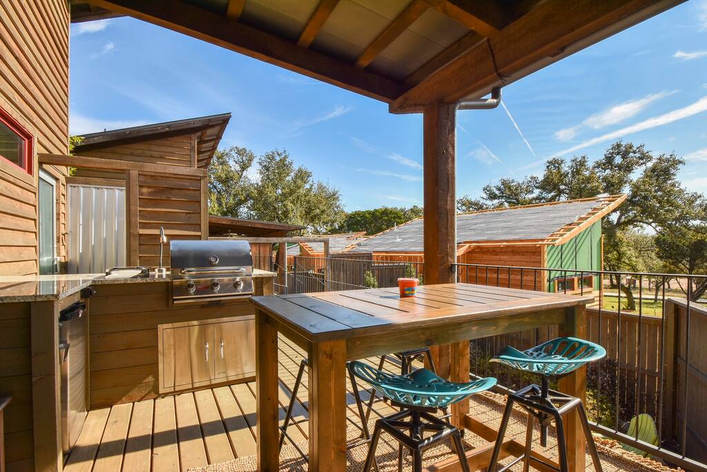 A rolling table with four bar stools and a set of chairs give you plenty of room to eat al fresco
