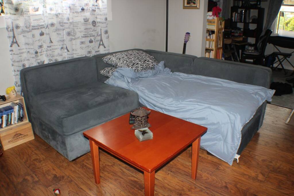 Cozy couch made up as your bed.
