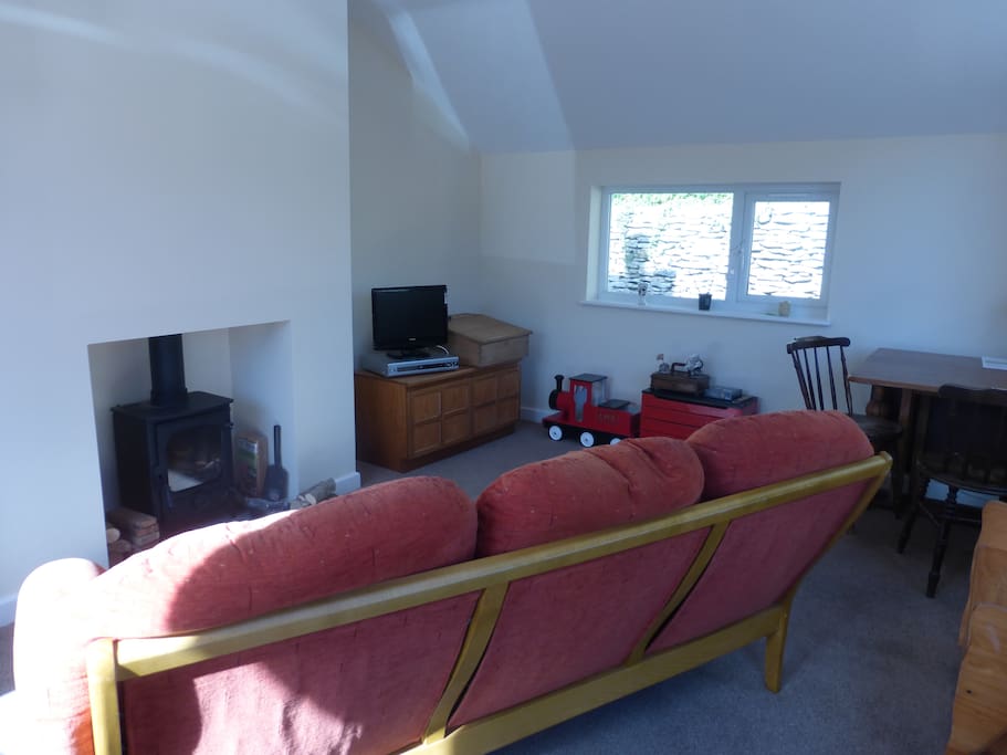 The living area and dining space with wood stove burner.