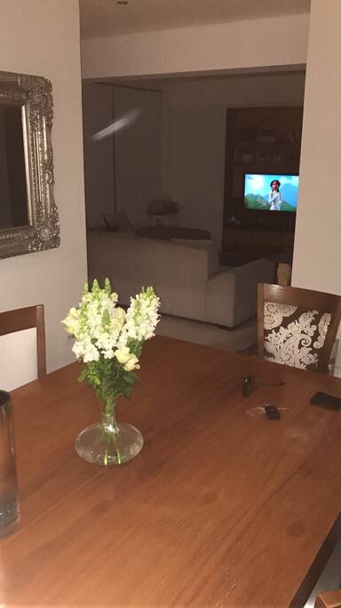 Open plan dining room leading to TV room/lounge area