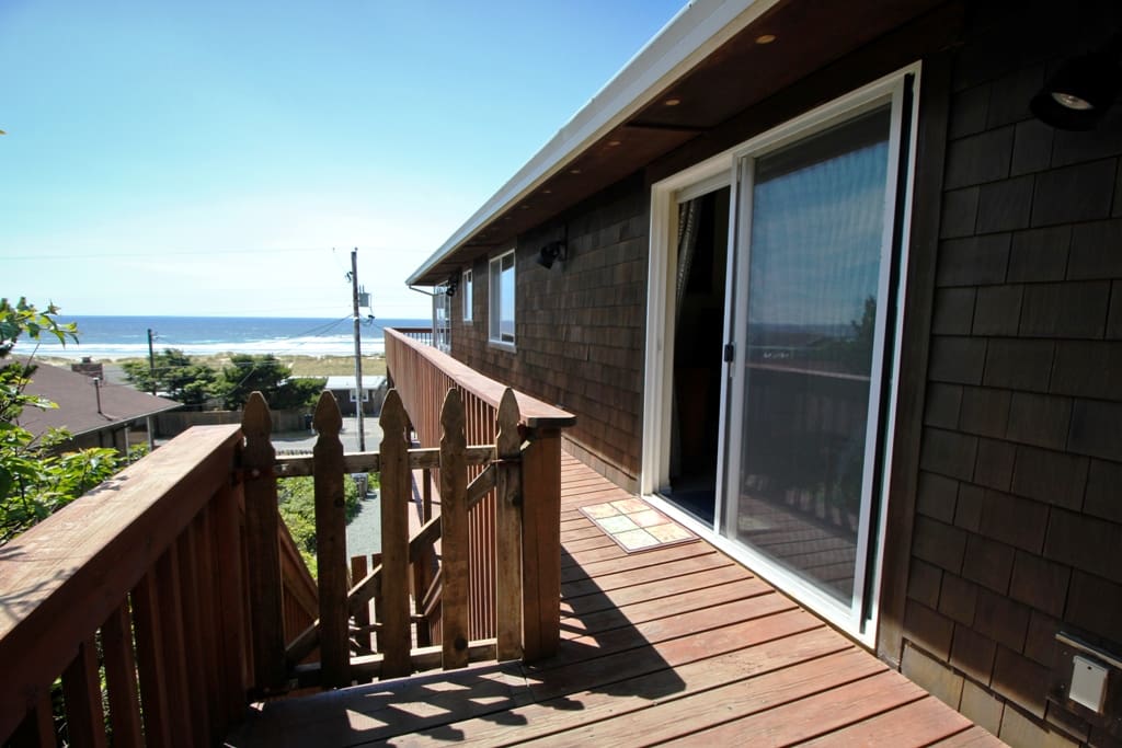Wrap around deck with spectacular ocean and Neahkahnie Mountain views. Stairs leading down to driveway.