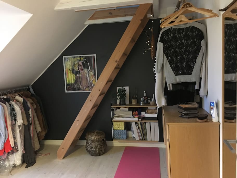 Lounge room with a synthesizer, books and a balcony turning to the West