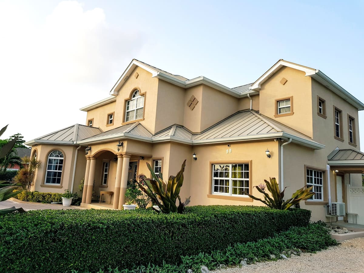 Property villa exterior and tropical gardens