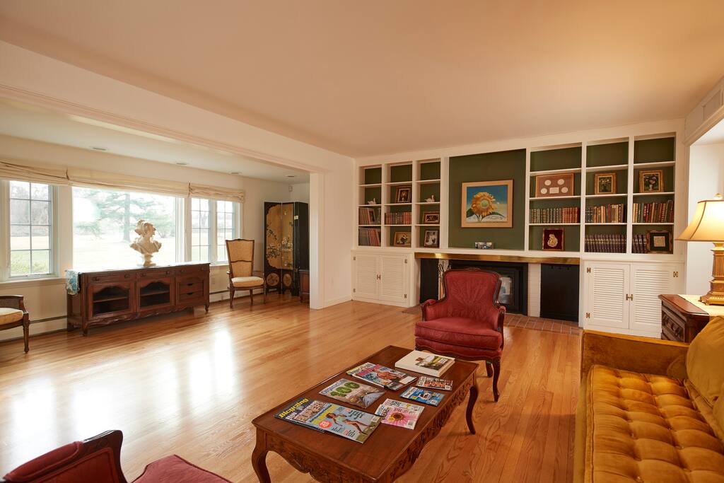 Living room with beautiful windows off of main entrance of house.