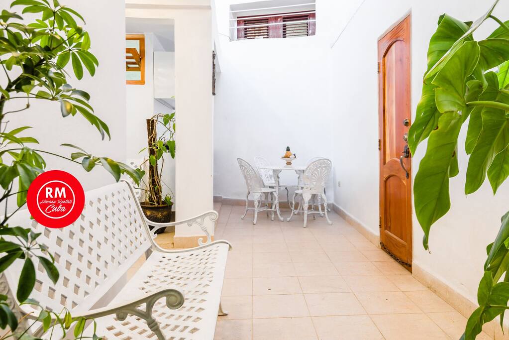 common area with small kitchen diner on the right apartment door access