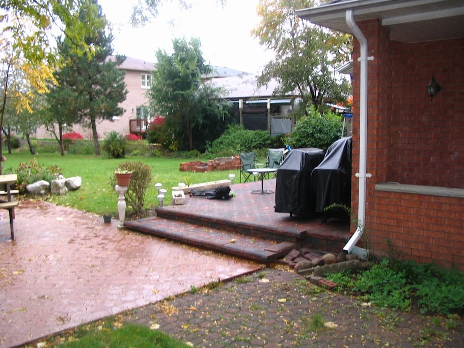 View of the back yard, deck and court yard.