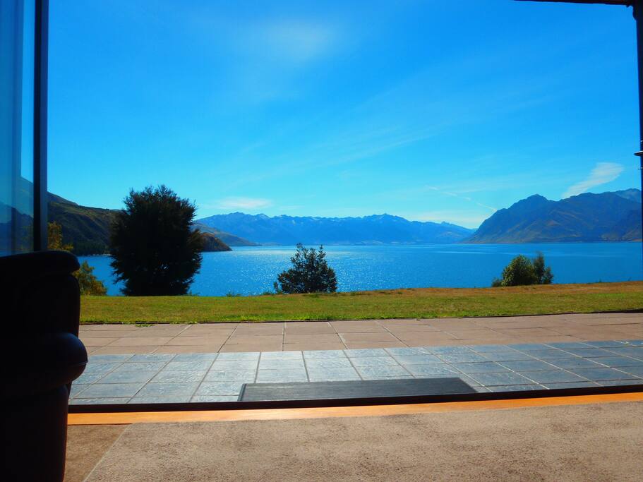 Lounge View with bifold doors open, enjoy reading on the seats outside with a lake view.