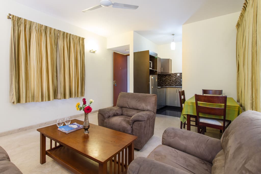 Living room with dining table and kitchen niche in the two bedroomed apartment on the middle floor