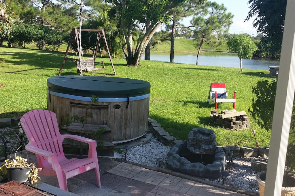 hot tub, fire pit patio and quiet backyard on a lake