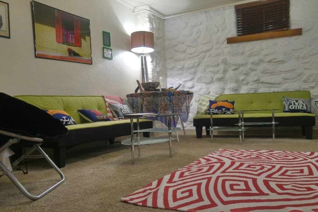 The equally-spacious downstairs living room. The two futons open into full size beds.