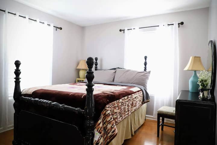 Bedroom 1 offers an antique queen sized bed with a chest and dresser with a mirror.  