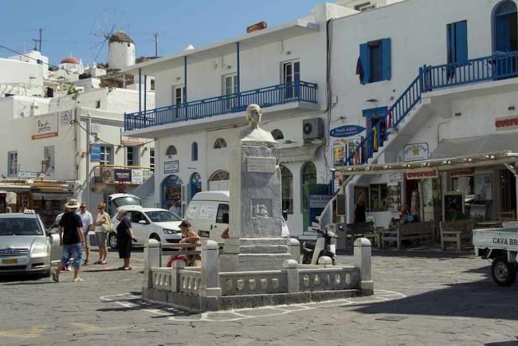 will welcome you to the statue of Manto in Mykonos Town.