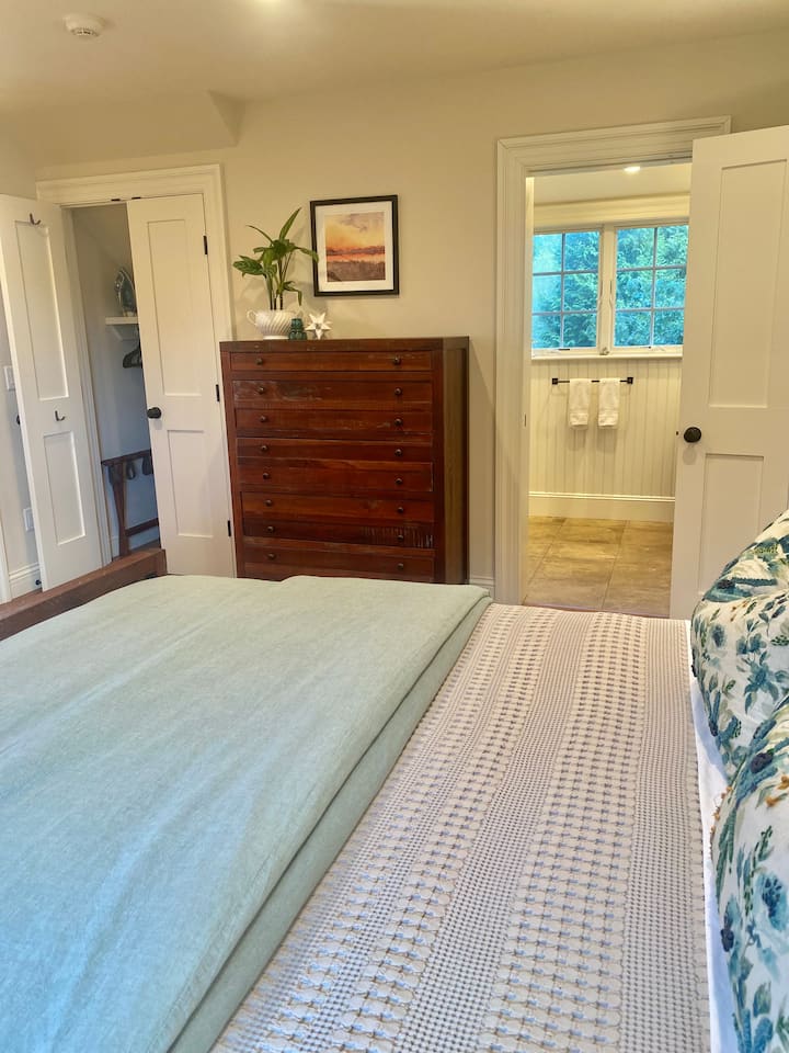 Looking in to the en suite bathroom. The exterior door leads to an outside staircase.  Plenty of storage in the dresser, closet and underbed drawers.