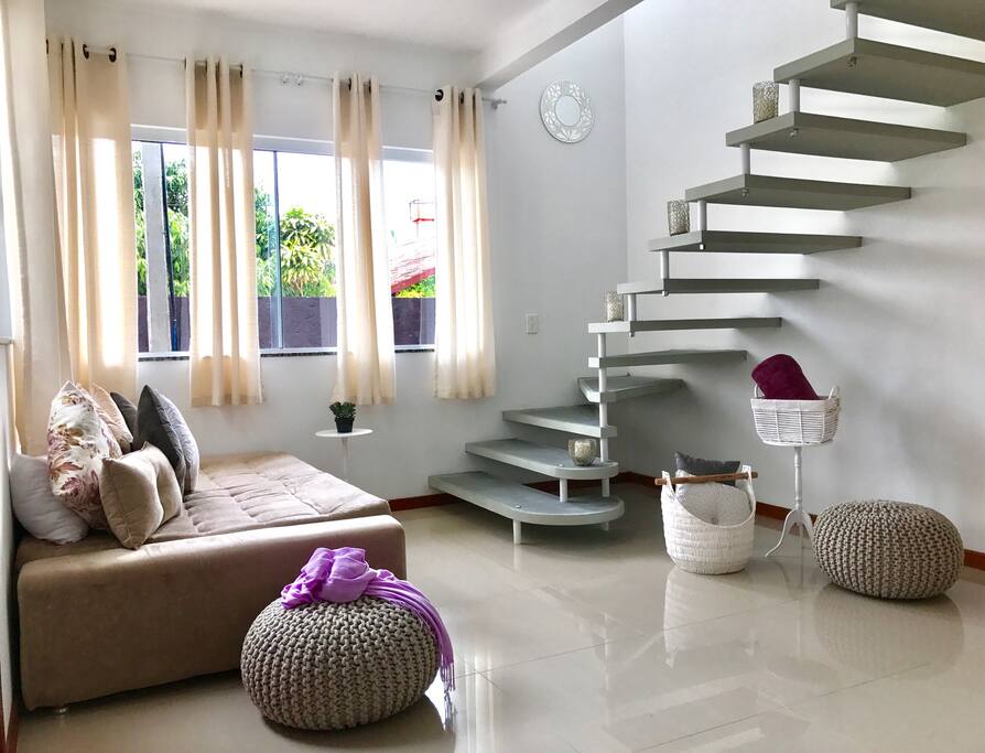 This is a view of the lounge area / sleeper couch from the kitchen. The house has alot of big glass windows that open up to give the house a beautiful sea breeze.