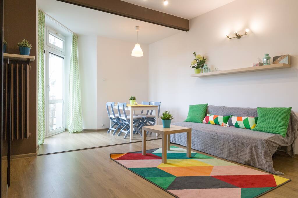 Living room with a dining area, folding sofa bed.