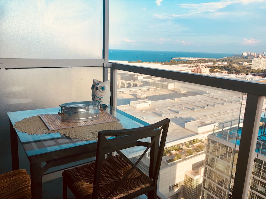 Balcony with seating and anti mosquito candle to enjoy Chicago’s warm breeze with a view of the lake