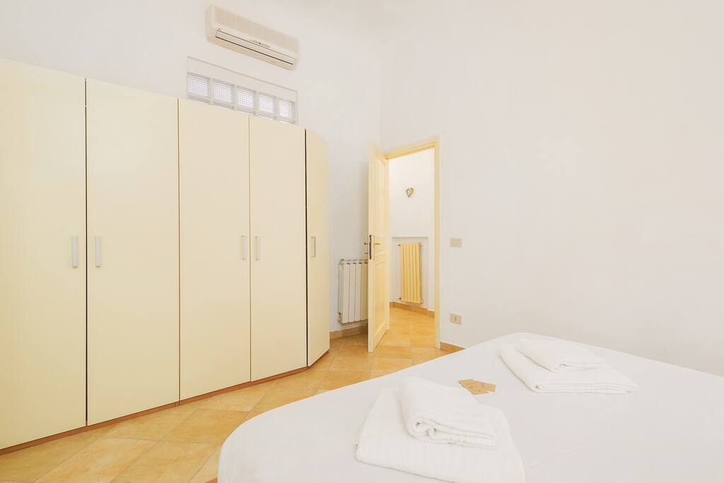 The Bedroom: the comfortable double bed with soft bed-linen and towels & the wardrobe