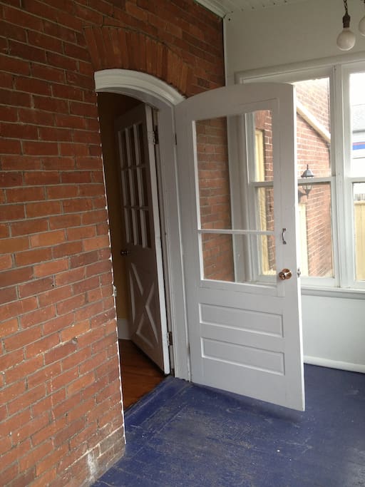 Screened in porch & entrance to apartment