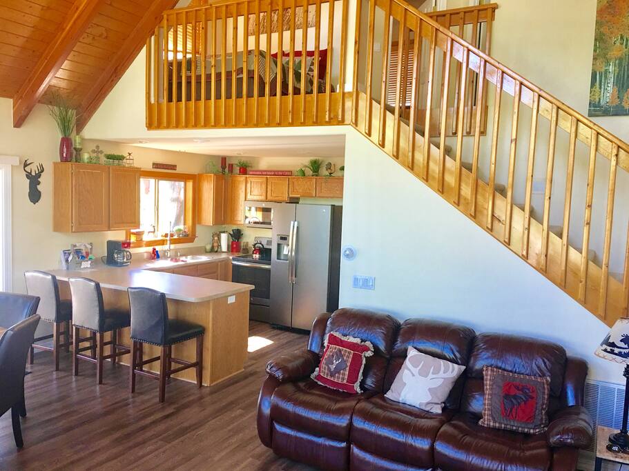 Living room view of kitchen. Everyone one can converse and be together with this open floor plan.Large living room features 2 comfortable reclining leather sofas as well as an additional sofa with a pull out bed(memory foam upgrades mattress)