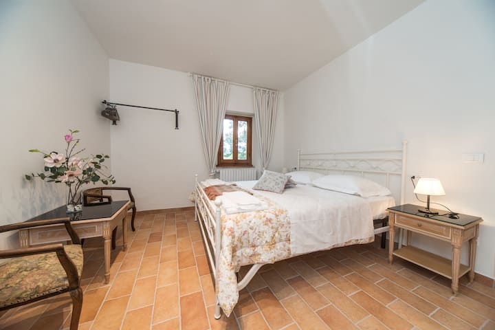 La chambre double 2 offre une vue magnifique sur l'ancien étang toscan niché dans le vignoble.
