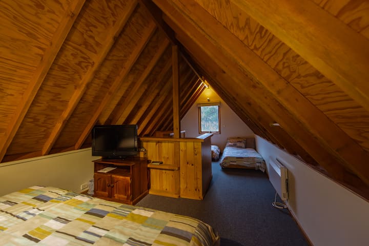 Loft bedroom with two singles and a king bed which can be split into two singles upon request