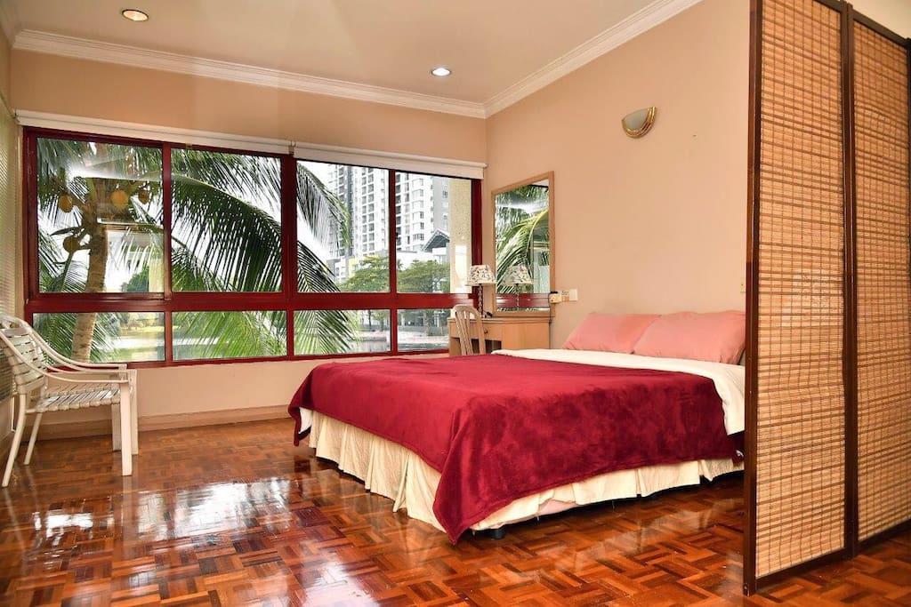 Master bedroom with king sized bed and attached bathroom