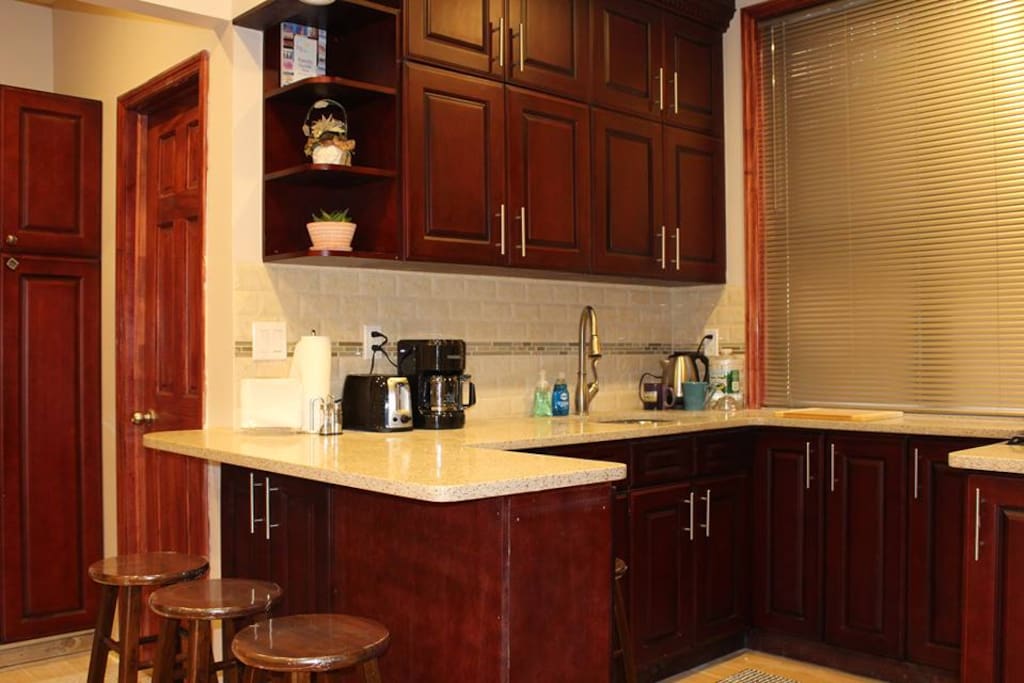 Open Floor Plan Kitchen with Stove, Fridge and equipped with essentials