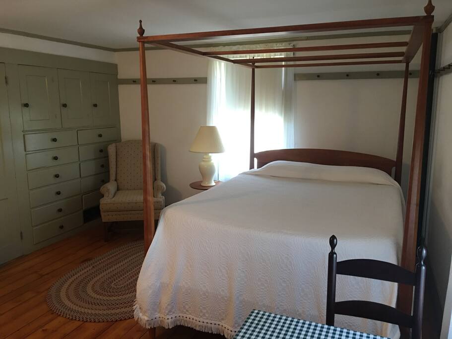 Bedroom features a small sitting table as well as some food amenities.