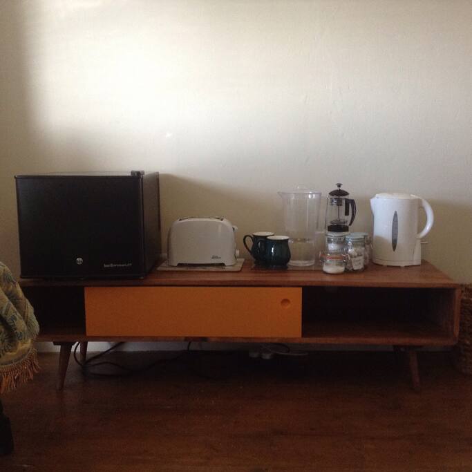A small fridge and full tea/coffee making facilities and a toaster.