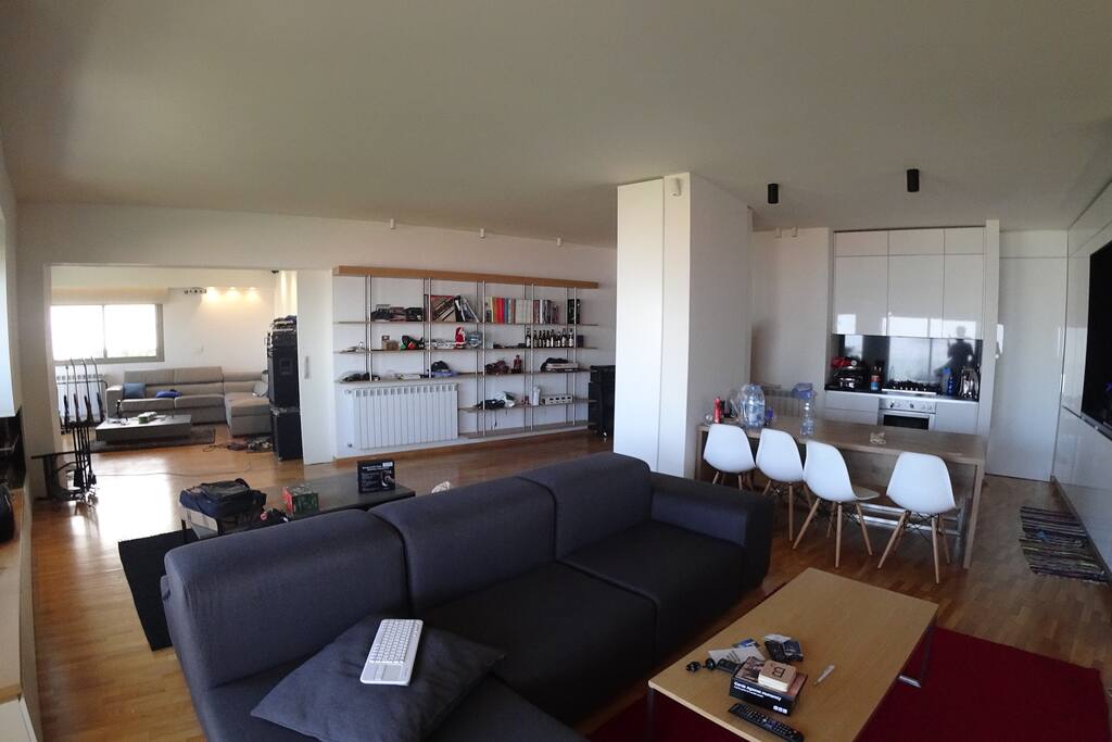 main seating area with entertainemt room on the left (with a 140" projection display)