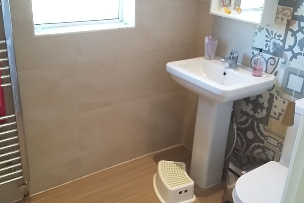 Private bathroom with bath and shower