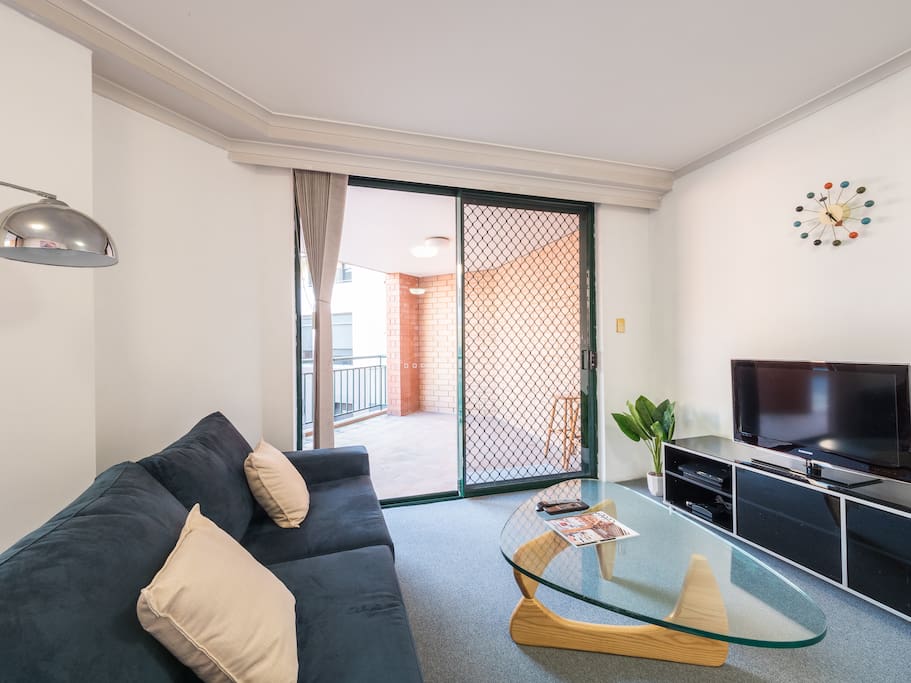 Spacious living area with sofa bed and entertainment unit