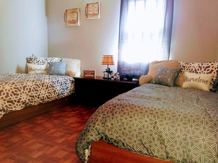 Bedroom 2 has two single beds with brand new mattresses and bedding. The room has a ceiling fan and full closet.