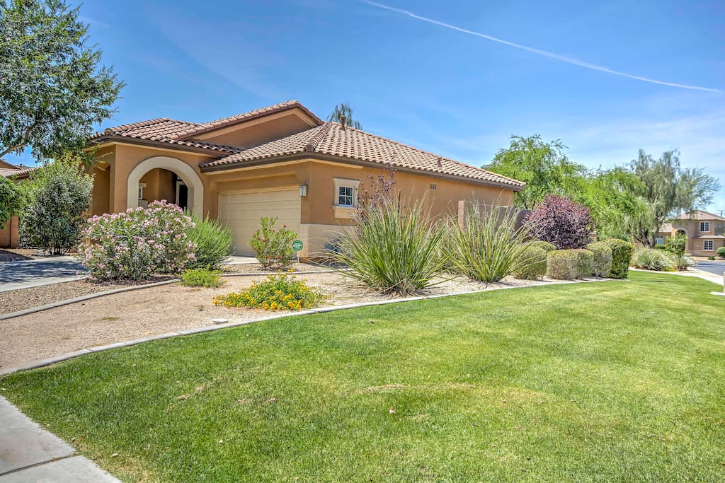 A beautifully landscaped front yard greets you as you arrive at the house.