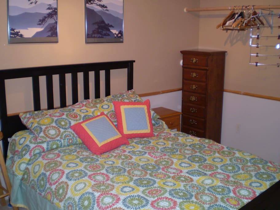 2nd bedroom with full size bed and space to hang clothes.