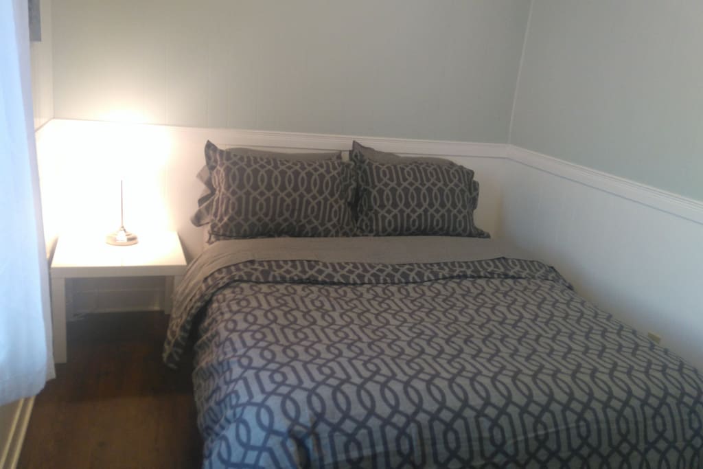 A cozy and clean room with a goose down duvet and fluffy pillows for a restful sleep.