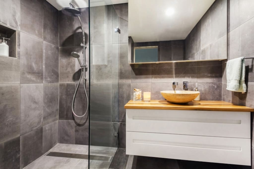 Beautifully appointed bathroom with large walk in rain shower