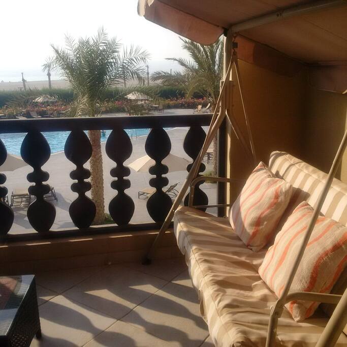 Pool and the beach with the sunset view