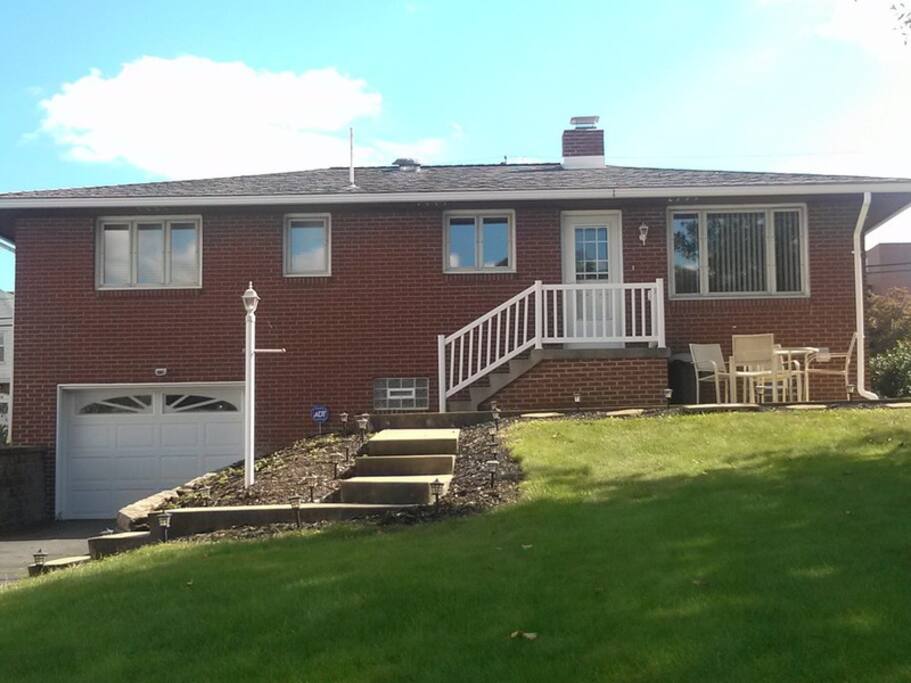 Back patio with seating and gas grill and additional parking