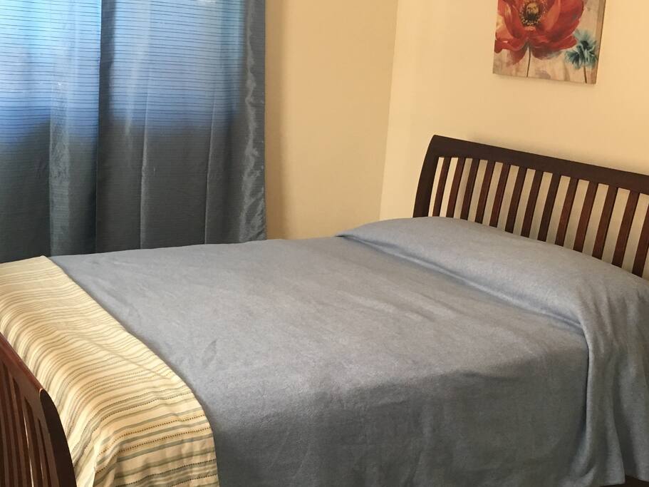 Master bedroom which includes comfy queen size bed, 2 windows, private bathroom with shower, closet with plenty of storage, and a futon couch