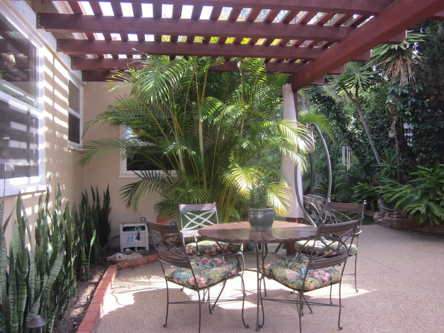 Outdoor Patio has Comfortable Table Seating in a Tropical Garden Setting.