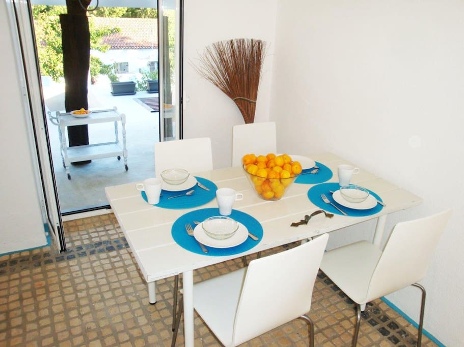 Dining table and door onto the terrace/garden where there is another covered table for meals outside.
