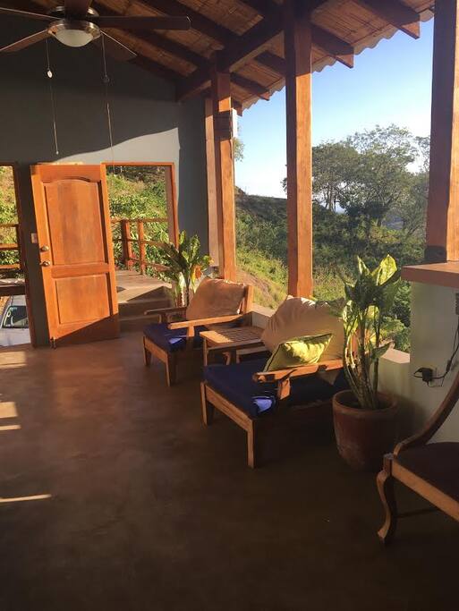Open air living room with picturesque ocean view and standing bar