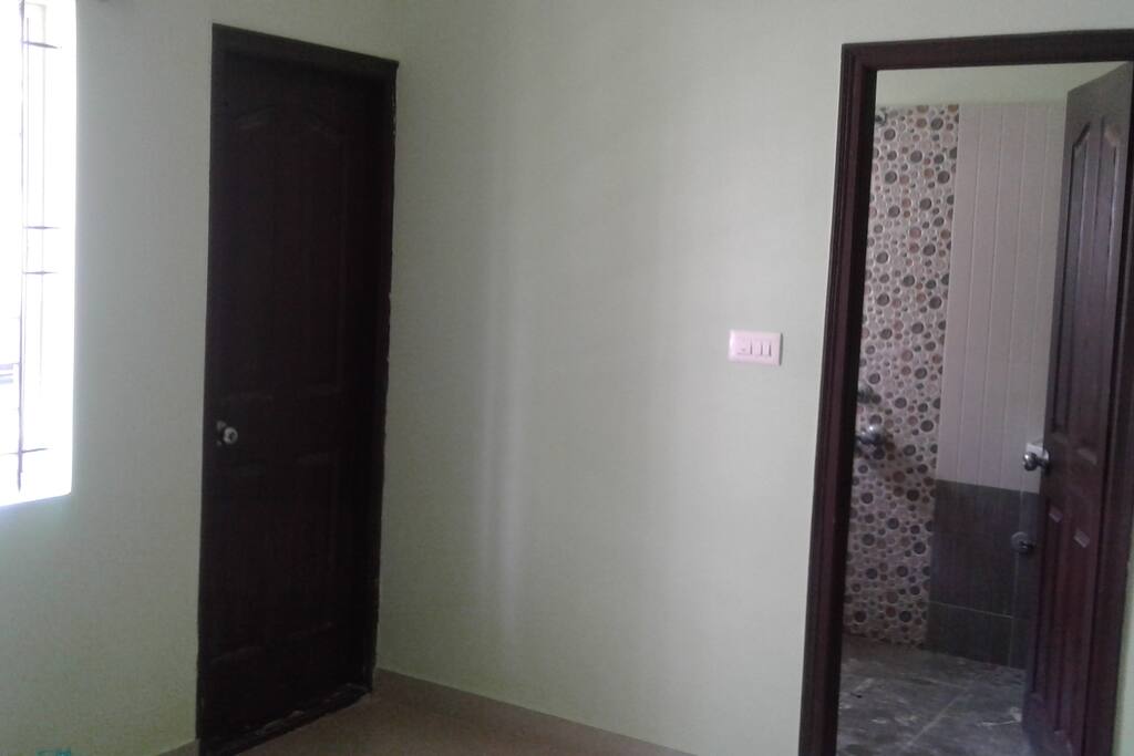 Master bedroom with attached bathroom and balcony