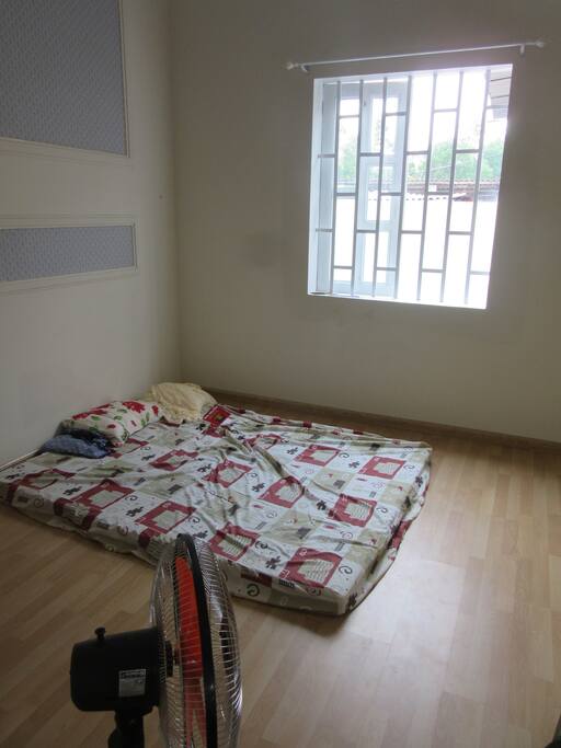 One of two identical bedrooms (pillows, sheets, fan, and mosquito net all provided).