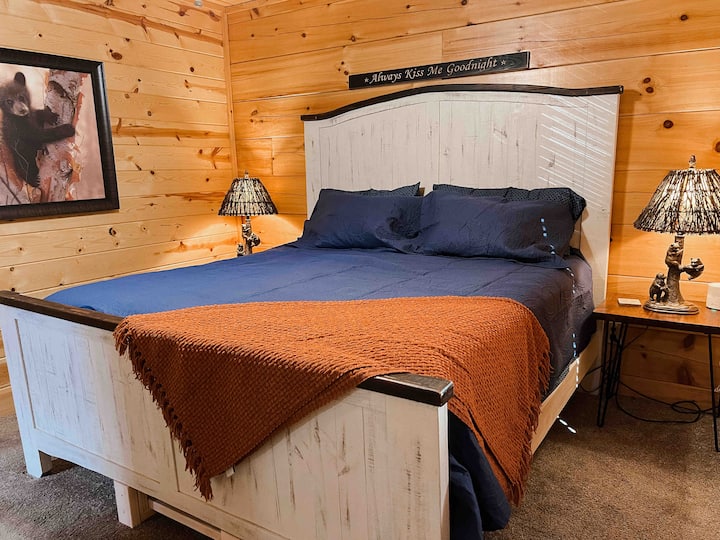 Bedroom 1: king-size bed with ensuite full bath on the main floor. Room includes a smart TV. 