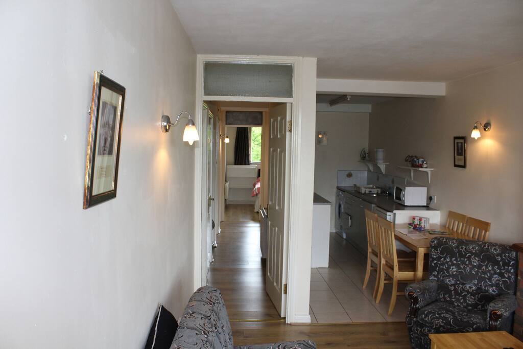 View from the Front door of the apartment of the Kitchen and Hallway leading to the back bedroom