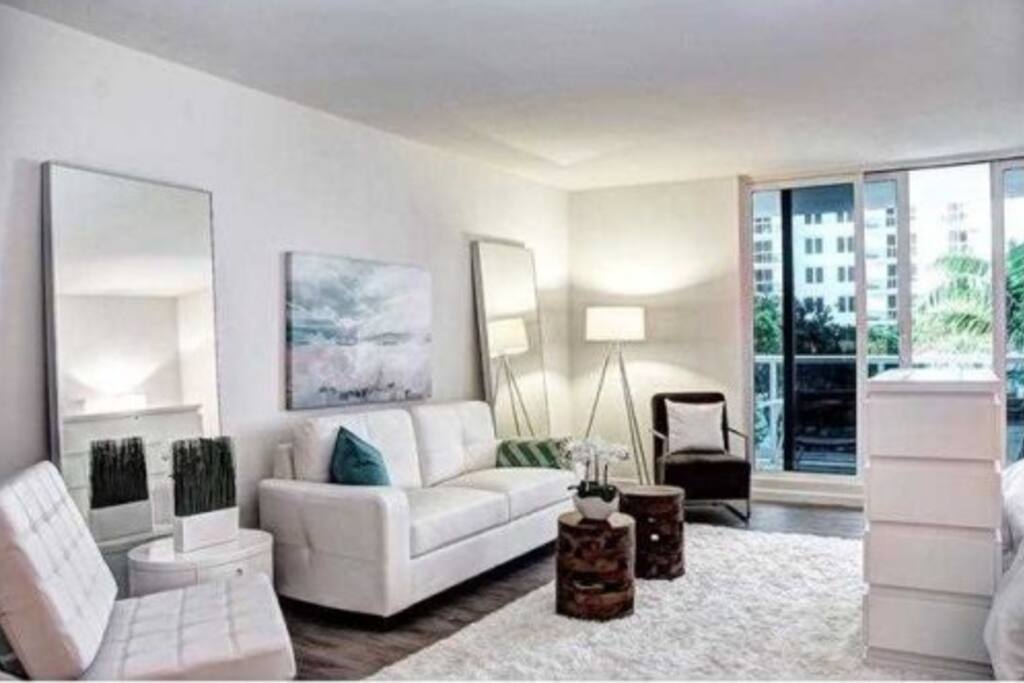 Living room features a 55" plasma HDTV that hides in the custom cabinet at the foot of the king size bed.