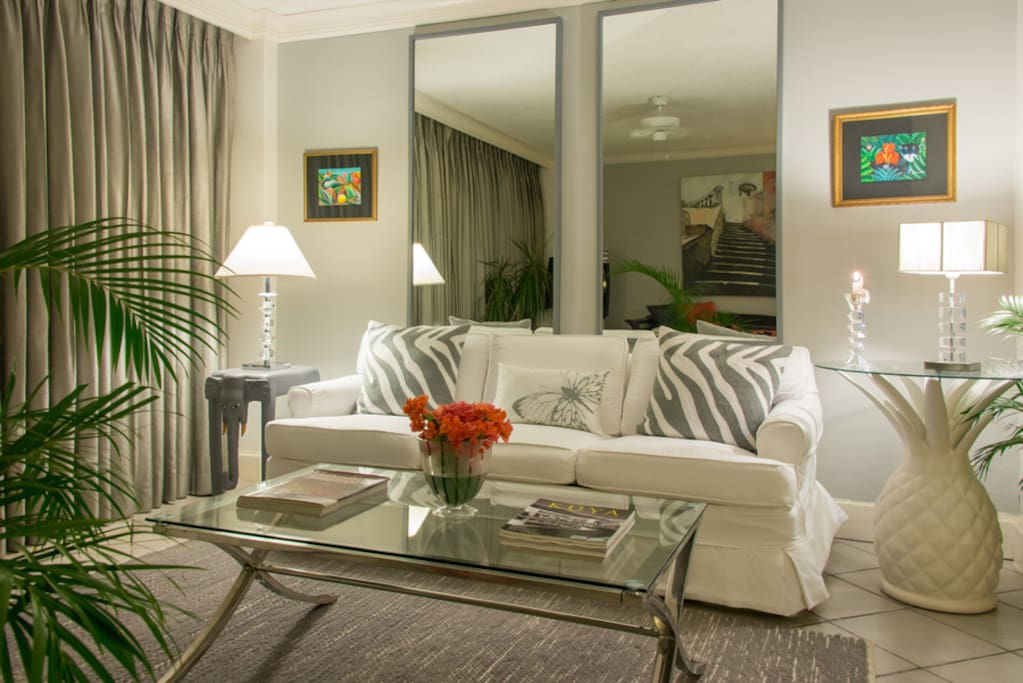 DOWNSTAIRS
The chic living area has handsome gray walls, crisp white fabric and tall mirrors that bring wide views into every corner. The sofa can convert to a queensize bed for one or two children. One of Mirador's two full bathrooms is also on this level.