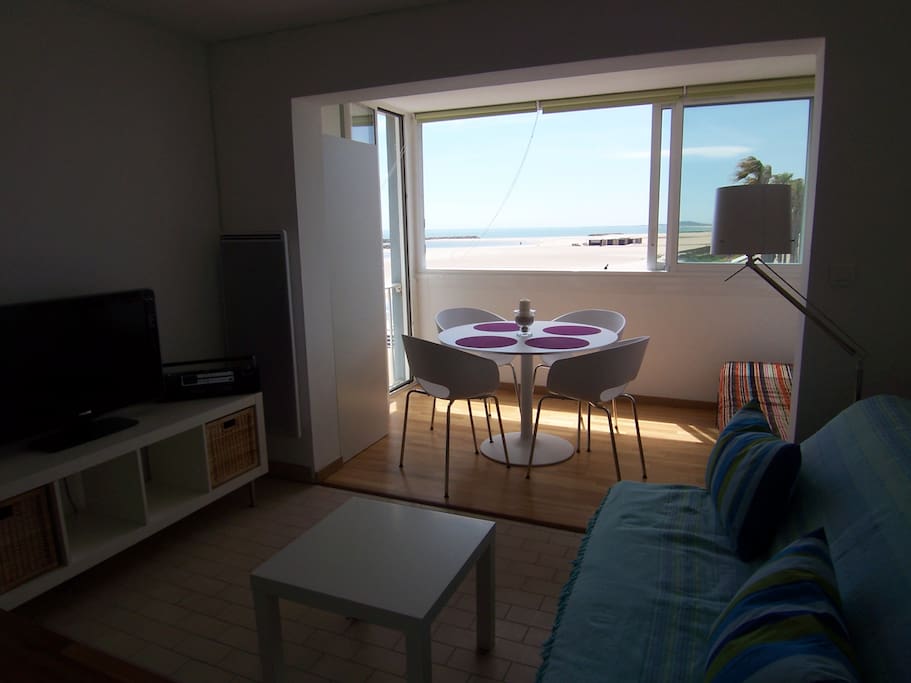 Salon avec grande télé et vue mer